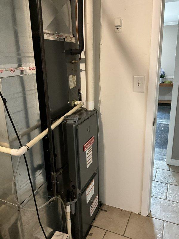 Conducted comprehensive estimate for complete HVAC system replacement involving new air conditioning unit and furnace installation. Assessed existing Goodman furnace setup in basement utility area, evaluated current ductwork configuration, PVC condensate drainage system, and electrical connections to determine scope of replacement work. Documented equipment specifications, installation space constraints, and necessary modifications to accommodate new high-efficiency heating and cooling system.