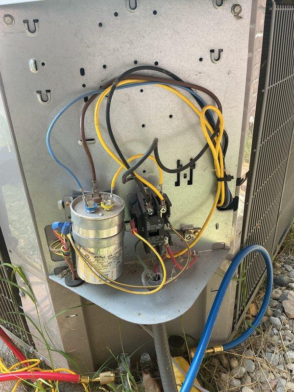 Completed comprehensive cooling maintenance on outdoor HVAC unit, including CCC (clean, check, calibrate) procedures and basic monthly service protocol. Performed thorough inspection of electrical components including capacitor, contactor, and all associated wiring connections; verified proper operation of compressor and fan motor circuits. Cleaned condenser coils, checked refrigerant lines and connections, and documented system condition with photos showing all major components including capacitor with blue and yellow terminal connections, black contactor relay, and color-coded wiring throughout unit. Customer requires 20x20x4 filter which was not included in this service visit.