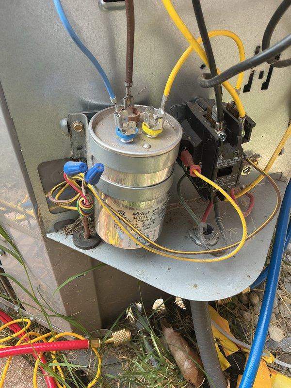 Completed comprehensive cooling maintenance on outdoor HVAC unit, including CCC (clean, check, calibrate) procedures and basic monthly service protocol. Performed thorough inspection of electrical components including capacitor, contactor, and all associated wiring connections; verified proper operation of compressor and fan motor circuits. Cleaned condenser coils, checked refrigerant lines and connections, and documented system condition with photos showing all major components including capacitor with blue and yellow terminal connections, black contactor relay, and color-coded wiring throughout unit. Customer requires 20x20x4 filter which was not included in this service visit.