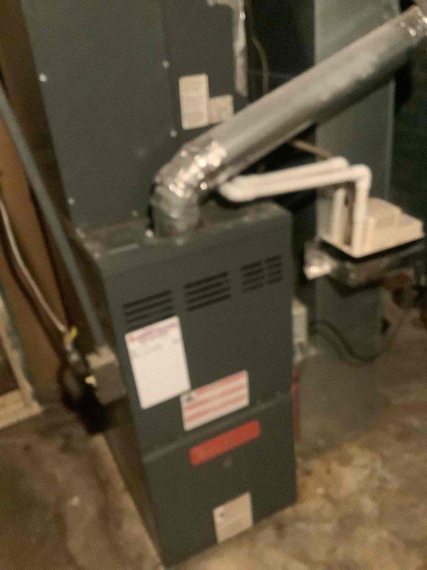 Responded to customer inquiries regarding their residential HVAC system, which consists of a gas furnace located in the basement utility area and an outdoor condensing unit. Documented current system configuration through photographic records showing the furnace with attached flexible ductwork and copper refrigerant lines, as well as the exterior condenser unit positioned on a concrete pad adjacent to the structure. Provided technical information and addressed questions to ensure customer understanding of their heating and cooling equipment.