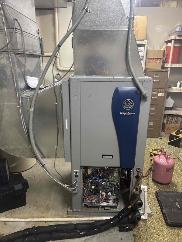 Returned to site to install domestic hot water coaxial heat exchanger on WaterFurnace geothermal unit. Accessed unit interior, installed DHW coax component, reconnected refrigerant lines and electrical connections, and verified proper operation of system upon completion.