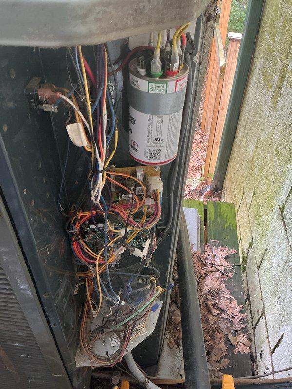 # HVAC Maintenance - Cooling System Service

Performed comprehensive cooling cycle check (CCC) and basic monthly maintenance on outdoor condensing unit and indoor air handler. Upon arrival, observed outdoor unit with accumulated leaf debris and organic matter around base and within cabinet, which was removed to prevent airflow restriction and potential component damage. Inspected electrical connections including capacitor terminals with multiple wire connections (red, yellow, black, brown) - all connections found secure with no signs of overheating or corrosion. Capacitor tested within acceptable parameters.

Examined indoor blower assembly including motor, housing, and mounting brackets. Blower wheel and motor shaft showed normal operational wear with minor dust accumulation typical of system age. All mounting hardware secure with no unusual vibration or movement detected. Copper refrigerant lines inspected with no visible damage or refrigerant leakage.

System operational testing con
