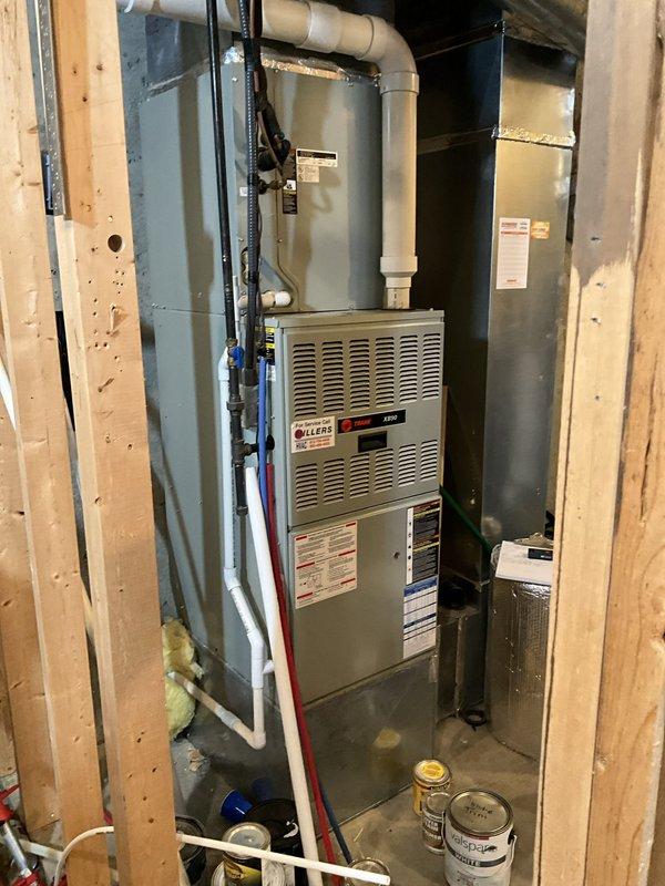 Completed HVAC system assessment for existing Trane XR80 furnace installation in residential basement utility area. Documented current equipment condition including forced air furnace unit, PVC ventilation and drainage system, ductwork configuration, and electrical connections. Prepared comprehensive replacement estimate for new HVAC unit based on observed system layout, existing infrastructure, and customer request following initial repair visit.