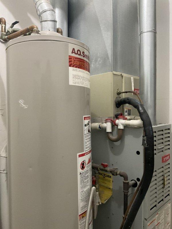 Conducted comprehensive site assessment at multi-unit apartment complex for full HVAC system replacement project involving 16 residential units. Evaluated existing equipment configuration including furnaces, water heaters, ductwork, and associated mechanical components to develop accurate replacement specifications. Documented current system conditions through photographic evidence showing Bryant furnace units, A.O. Smith water heaters, metallic ductwork installations, copper and PVC plumbing connections, and expansion tanks in typical utility closet configurations. Confirmed scope of work with property management for complete system replacement across all units.