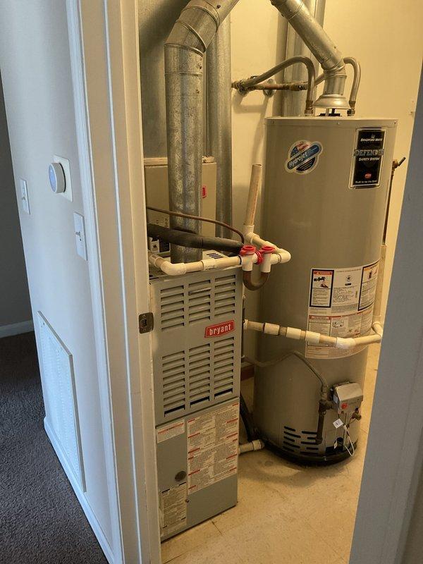 Conducted comprehensive site assessment at multi-unit apartment complex for full HVAC system replacement project involving 16 residential units. Evaluated existing equipment configuration including furnaces, water heaters, ductwork, and associated mechanical components to develop accurate replacement specifications. Documented current system conditions through photographic evidence showing Bryant furnace units, A.O. Smith water heaters, metallic ductwork installations, copper and PVC plumbing connections, and expansion tanks in typical utility closet configurations. Confirmed scope of work with property management for complete system replacement across all units.
