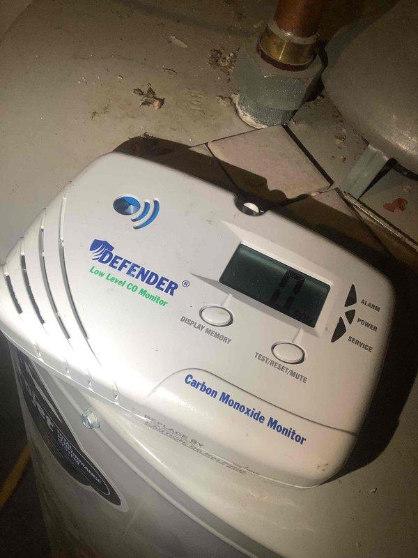 Responded to service call for combustion safety analysis. Upon arrival, discovered combustion analyzer was non-functional and unable to complete required testing. Inspected DEFENDER low-level carbon monoxide monitor in mechanical area, which displayed a reading of 93 PPM. Documented existing conditions with photos showing CO monitor placement near gas piping and copper plumbing infrastructure in utility space. Scheduled return visit with operational combustion analyzer to complete comprehensive combustion safety testing and system diagnostics.