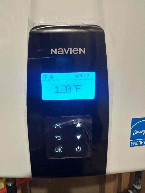 Responded to customer inquiries regarding Navien NPE-240A2 natural gas instantaneous water heater operation and specifications. Documented unit model and serial number information, confirmed EnergyGuide energy efficiency ratings, and verified proper functioning of wall-mounted control panel displaying temperature settings at 120°F and flow rate indicators.
