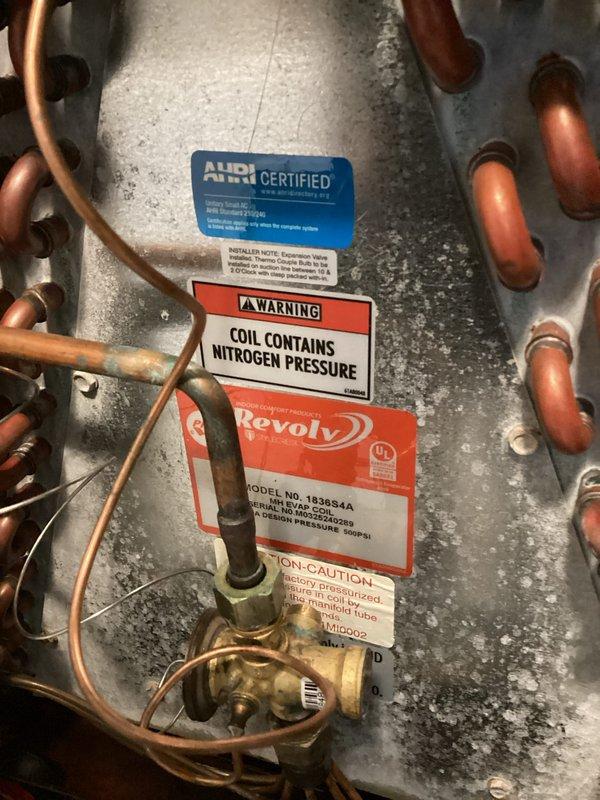 Performed comprehensive tune-up on Revolv HVAC system, including inspection of evaporator coil assembly and blower wheel components. Verified proper operation of refrigeration lines, inspected copper tubing connections and brass fittings for leaks, and confirmed nitrogen pressure retention in coil. Examined squirrel cage blower fan assembly, motor housing, and mounting hardware for proper operation and cleanliness. Located and showed customer the air filter access point for future maintenance reference, and discussed available membership program options for ongoing system care.