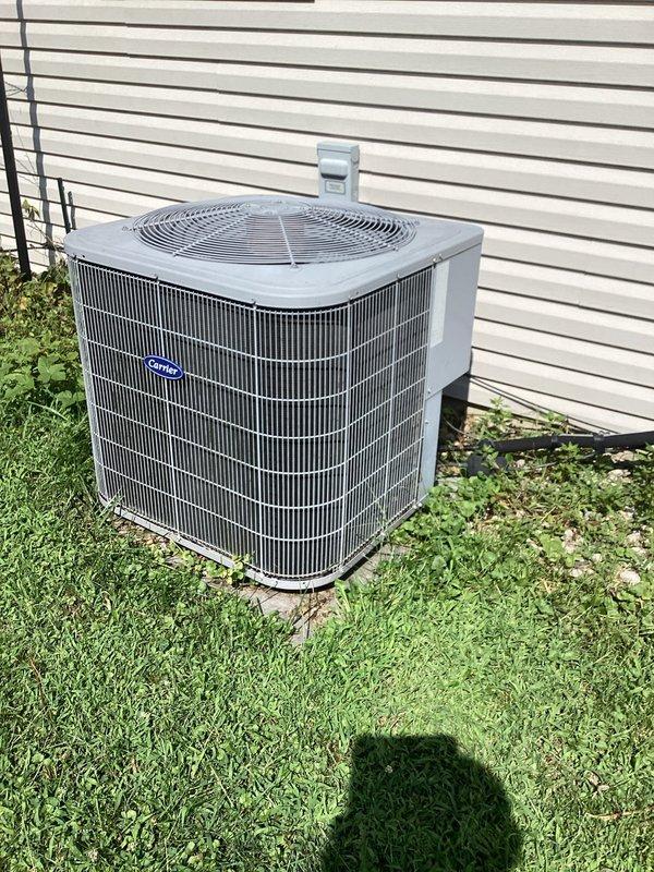 Responded to service call for outdoor AC condenser unit producing loud noise during nighttime operation while maintaining cooling capacity. Upon arrival, performed comprehensive system inspection of condenser unit located on exterior concrete pad. Visually assessed condenser cabinet, fan assembly, and coil condition. Unit appeared well-maintained with clean condenser coils showing no visible debris accumulation, rust, or physical damage to cabinet or components. 

Inspected top-mounted fan assembly through protective grille, checking for potential sources of noise including fan blade condition, motor mount integrity, and bearing wear. Evaluated condenser coil fins for proper alignment and airflow obstruction. Verified unit was operating on stable concrete pad with no settling issues that could contribute to vibration or noise.

Proceeded indoors to assess system controls and verify proper thermostat operation. Inspected Honeywell digital thermostat set to 72 degrees, confirmed display 