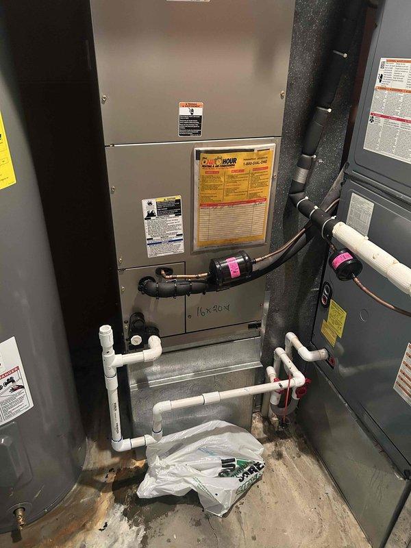 Responded to service call for rusty colored water discharge from air conditioning unit. Upon inspection, found air filter heavily rusted and saturated with water, indicating significant condensate drainage issue or possible evaporator coil leak. Documented equipment conditions including thermostat operation showing system in cooling mode and photographed HVAC equipment setup with condensate drain lines for further diagnostic evaluation.