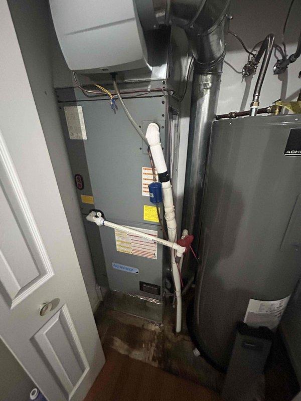 Completed Comfort Care monthly maintenance on residential cooling system. Performed comprehensive inspection of furnace and air handler unit, verified proper operation of smart thermostat displaying 74°F in cooling mode, and inspected all mechanical components including ductwork, PVC condensate drainage lines, and associated plumbing connections in utility room.