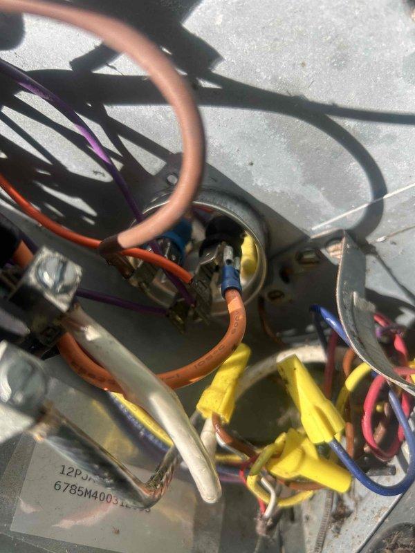Responded to no cooling complaint affecting entire residence. Upon arrival, performed comprehensive system diagnostics on split air conditioning system. Inspected indoor air handler unit located in utility closet, noting age-related wear and environmental conditions including ceiling water damage and deterioration in mechanical room. Examined outdoor condensing unit and electrical connections, documenting wiring configuration with multiple circuits converging at capacitor terminals. Verified proper wire connections using appropriately rated wire nuts for all power and control circuits. Evaluated refrigerant charge levels and system pressures to determine root cause of cooling loss following recent service by another provider. Documented equipment condition through photographic evidence showing internal electrical components and air handler installation. System assessed for potential refrigerant leak, electrical faults, and airflow restrictions.