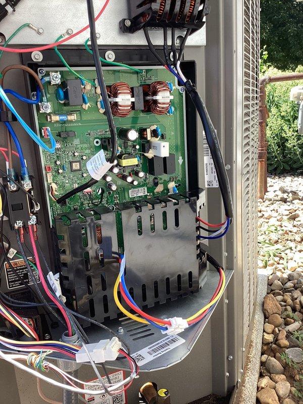 Serviced outdoor heat pump unit and inspected inverter control board assembly. Verified proper wire routing to ensure low voltage control wiring was separated from high voltage power lines per manufacturer specifications to prevent electrical interference and potential system malfunctions. Documented control board condition, wiring connections, and component layout with photos showing PCB with toroidal inductors, heat sink assembly, and all wire harness connections properly secured and terminated.