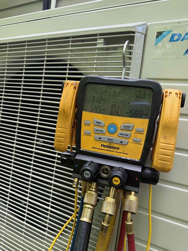 Replaced failed Daikin mini split system under manufacturer warranty. Performed complete system installation, evacuated refrigerant lines, charged system to specifications, and verified proper operation with supply air temperature reading 87.1°F and confirmed system pressures within normal operating range.
