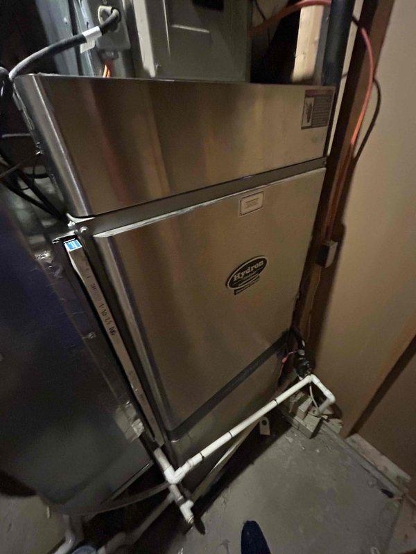 Responded to no cooling complaint with indoor temperature at 75°F. Performed diagnostic evaluation of residential HVAC system and documented thermostat reading at 76°F. Inspected furnace unit, refrigerant lines, and associated mechanical components in utility closet to identify cause of cooling failure.