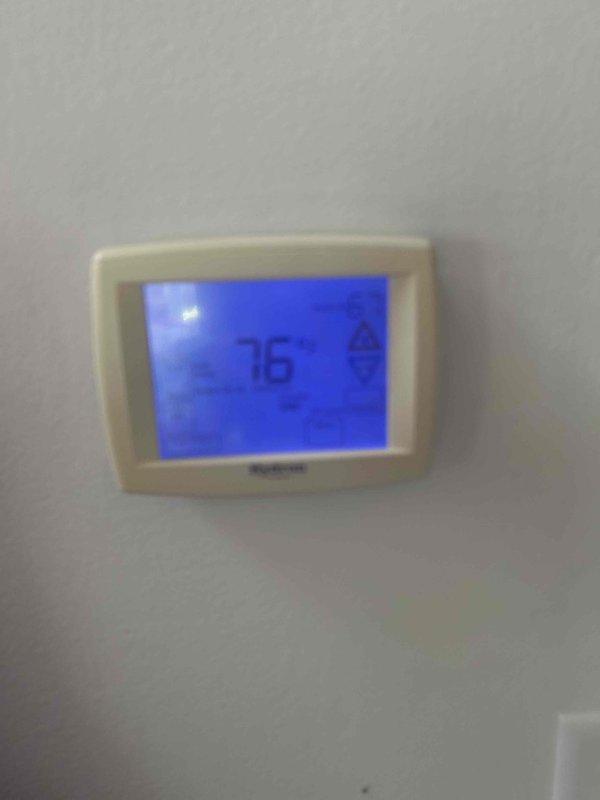 Responded to no cooling complaint with indoor temperature at 75°F. Performed diagnostic evaluation of residential HVAC system and documented thermostat reading at 76°F. Inspected furnace unit, refrigerant lines, and associated mechanical components in utility closet to identify cause of cooling failure.