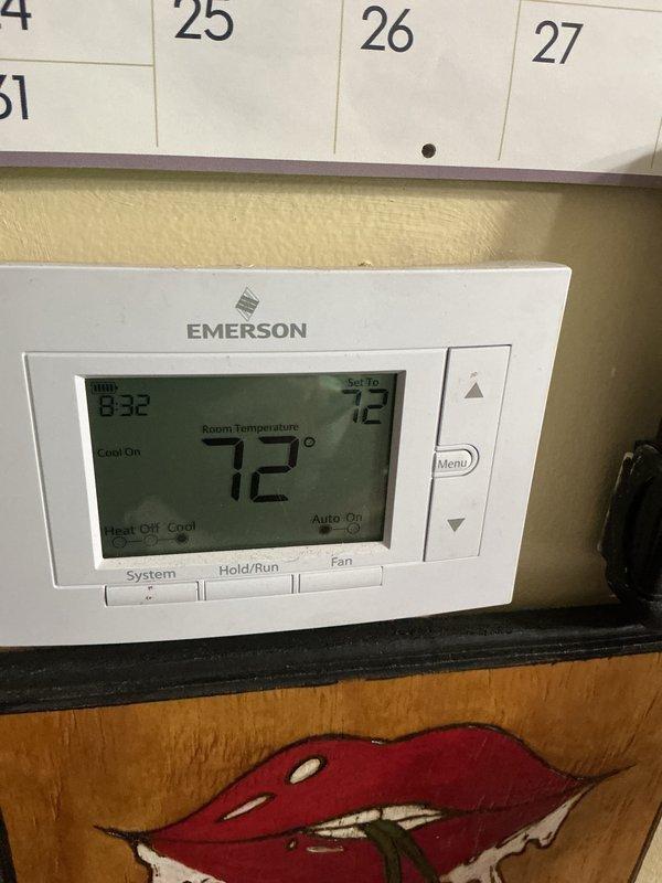 Completed CCC Basic Monthly Filter maintenance service on residential cooling system. Verified thermostat operation showing system actively cooling with setpoint at 72°F and proper display function. Inspected evaporator coil and surrounding air handler components, noting dust accumulation on coil fins and confirmed refrigerant lines intact with visible patina consistent with normal aging.