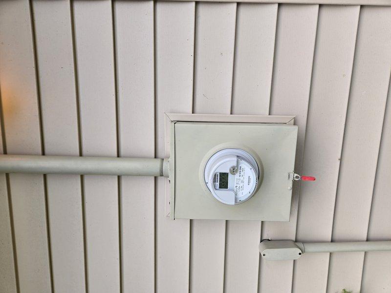 Conducted site visit to assess electrical system experiencing flickering lights despite having a 200A panel. Inspected existing electrical meter installation and main service panel, documenting current configuration with multiple circuit breakers ranging from 20A to 40A capacity. Evaluated electrical infrastructure requirements for installation of new electrical panel upgrade and dedicated wiring circuits for heat pump water heater system.