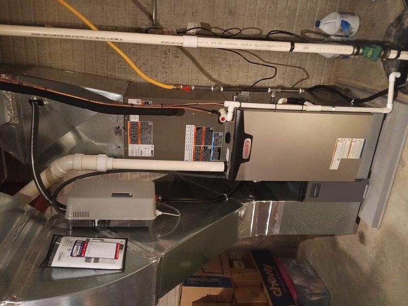 Completed full HVAC system installation featuring Lennox air conditioning unit and gas furnace in basement utility area. Installed new equipment with proper electrical connections, PVC condensate drain lines, and venting system, ensuring all components meet manufacturer specifications and local code requirements. Configured system with Honeywell 16x25x4 filtration and verified proper operation of all heating and cooling functions upon startup.