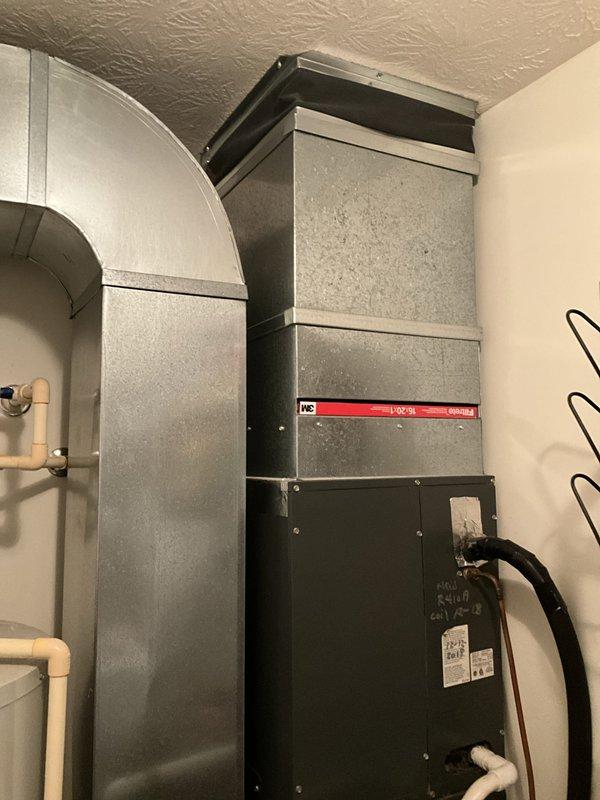 Performed comprehensive assessment of failed 2006 residential cooling system that experienced complete refrigerant loss resulting in coil freeze-up. Evaluated existing indoor air handler with red manufacturer branding and outdoor cylindrical condenser unit with ribbed metal grille to provide second opinion on full system replacement. Documented current equipment condition, refrigerant line routing, electrical connections, and installation configuration including ductwork transitions and mounting locations to develop replacement estimate specifications.