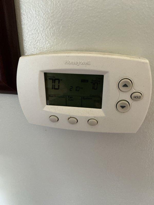 Performed comprehensive cooling system maintenance on residential HVAC unit under active comfort care agreement. Inspected outdoor condensing unit with exposed electrical components, including Turbo 200 capacitor with multiple wire connections; verified proper terminal connections and electrical integrity. Checked indoor Honeywell programmable thermostat displaying 73°F setpoint and confirmed proper system communication and control functions.