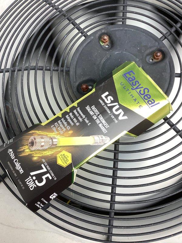 Responded to return service call for recurring issue. Measured supply air temperature at 87.4°F and inspected condenser unit. Applied EasySeal UV leak detection product to identify refrigerant leak in system. Trip fee waived by office due to recent previous service visit for same concern.