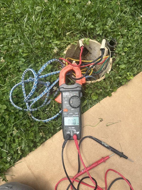 Responded to no water service call and performed diagnostic testing on well pump system. Used clamp meter to verify electrical supply to pump motor, confirming proper voltage present at the unit. Pump failed to start despite adequate power supply, indicating mechanical failure of pump assembly. Inspected pressure tank system and associated plumbing connections. Documented conditions for follow-up pump replacement and water flow restoration by plumbing specialists.