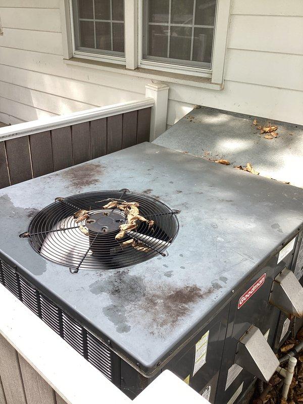 Completed rescheduled cooling maintenance on Goodman outdoor condensing unit. Performed comprehensive cooling check including system inspection, cleaning, and filter replacement with 20x25x1 filter. Unit showing age-related exterior weathering with surface rust on top panel and accumulated debris, but system operational. Cleaned accumulated leaves from top of unit and surrounding platform area. Verified refrigerant lines, electrical connections, and overall system performance. All operating parameters within acceptable range. Customer Cool Care Club membership renewed through July 30, 2026.