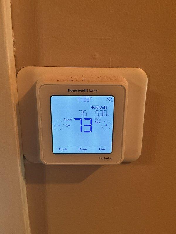 Completed annual cooling system maintenance visit. Verified system operation with supply air temperature measuring 52.08°F at floor register. Confirmed thermostat functioning properly in cooling mode with setpoint at 73°F and system maintaining scheduled hold settings. Replaced 20x20x4 air filter as included with active service agreement.