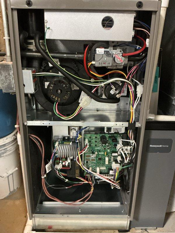 Completed annual cooling maintenance visit on residential HVAC system. Performed comprehensive inspection of furnace and air handling components, verifying proper operation of gas valve assembly, blower motor, and control board. Inspected Honeywell control board for proper connections and functionality, confirmed all wire harnesses securely connected with no signs of overheating or damage. Verified Lennox thermostat operation, displaying 72°F indoor temperature with system set to cool to 72°F, heating setpoint at 69°F, and outdoor temperature reading 84°F. Confirmed humidity level at 52% and thermostat communication with HVAC equipment functioning correctly. Inspected blower motor assembly and pulley system for proper operation and alignment. Provided 16x25x1 air filter as part of maintenance agreement. All system components operating within normal parameters with no deficiencies noted at time of service.