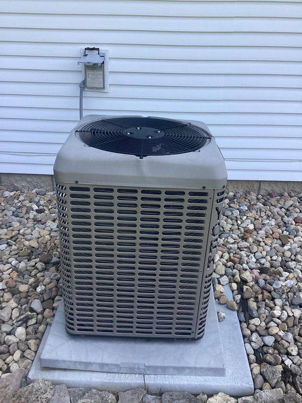 # HVAC Service Report

Responded to emergency service call for 2-year-old air conditioning system running but not cooling. Upon arrival, found Honeywell Home ProSeries thermostat displaying 78°F with system set to off and fan running continuously. Inspected outdoor condenser unit located on concrete pad with proper clearance from home's exterior. Unit appeared in good physical condition with clean coil fins visible through louvered panels and fan grille intact. Performed diagnostic testing to identify cooling failure. Determined root cause and completed necessary repairs to restore proper cooling operation. System tested and verified operational before departure.