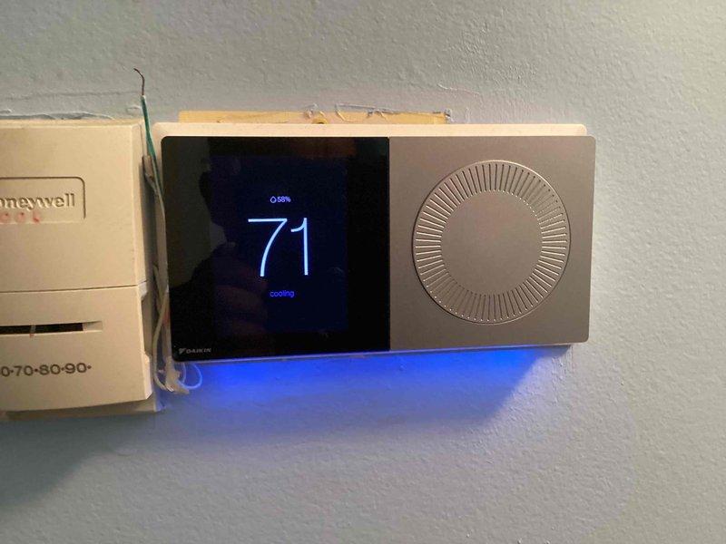 Completed routine maintenance and tune-up on 4-year-old central air conditioning and heating system. Performed comprehensive inspection of both units, verified proper operation of all components, checked refrigerant levels, cleaned condenser coils, inspected electrical connections, and tested thermostat functionality. Installed new Honeywell digital thermostat showing cooling mode at 71 degrees with proper system response. All equipment operating within normal parameters with no issues identified. System confirmed in good working condition.