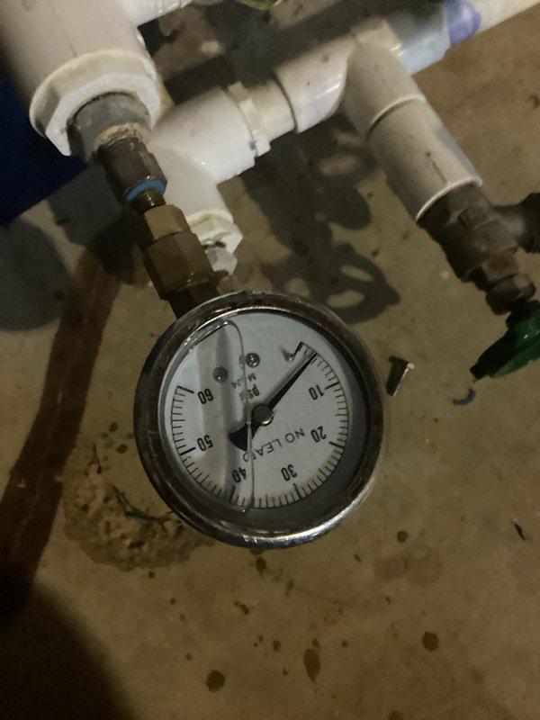 Responded to service alert on geothermal cooling system. Inspected loop pressure gauges and found system pressure within acceptable range; verified all shutoff valves and connections at manifold assembly were secure and functioning properly. Cleared service alert code from thermostat after confirming proper system operation.