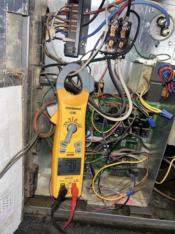 Responded to high pressure warning displayed on system. Performed diagnostic testing of electrical control panel and measured amperage draw at 23.0 amps using clamp meter to verify compressor operation and identify potential causes of high pressure condition.