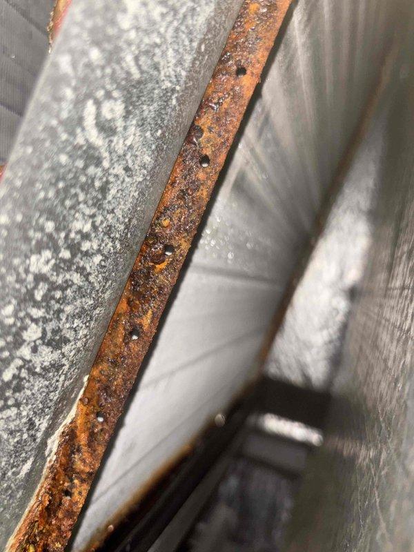 # HVAC Maintenance Summary

Completed basic monthly cooling maintenance on two T-TAN systems located in basement utility area. Performed standard inspection protocols including visual assessment of equipment condition, ductwork integrity, and electrical connections. Documented significant corrosion on metal ductwork components and mineral deposits on galvanized surfaces, indicating potential moisture infiltration issues that may require future attention to prevent system degradation.