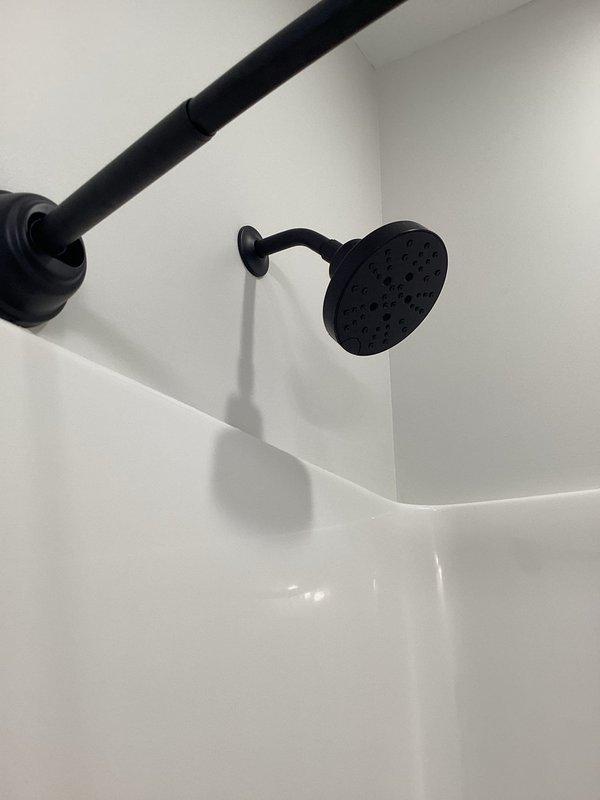 Completed comprehensive plumbing inspections on both units of a duplex property. All fixtures, including bathroom shower installations with matte black hardware and wall-mounted showerheads, were examined and found to be in proper working condition with no leaks or deficiencies noted.