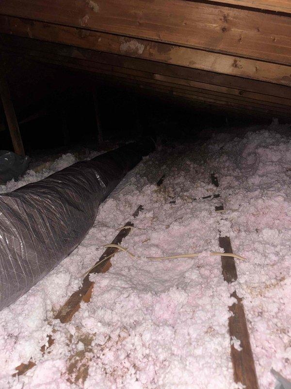 Crew scheduled to return to attic space to correct and replace hard pipe return ductwork. Visual inspection documented existing flexible duct installation with insulation coverage and identified areas requiring rigid return air duct modification to meet warranty specifications.