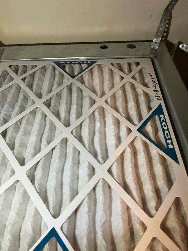 Completed monthly cooling maintenance visit on residential CCHP system. Inspected outdoor condenser unit positioned on concrete pad adjacent to building—verified proper clearances, examined coil fins for debris accumulation, and confirmed fan grille protection in place. Checked electrical connections at exterior disconnect and confirmed secure conduit mounting. Evaluated indoor air handler and replaced 16x20x1 disposable filter showing moderate dust loading with discoloration throughout pleated media. All system components operational and functioning within normal parameters at time of inspection.