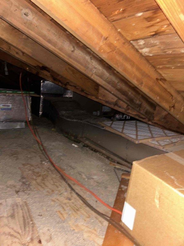 Responded to no cooling call and performed diagnostic evaluation of residential HVAC system. Inspected attic-mounted air handler and ductwork, verified thermostat operation showing dual-zone control with Emerson unit and digital touchscreen displaying 74°F room temperature with 69°F setpoint. Documented equipment location and system configuration for service records.