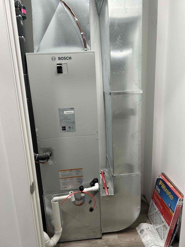Responded to service call for non-responsive heat pump and clogged condensate drain line on Bosch air handler system. Successfully cleared blockage from furnace condensation drain line using appropriate methods to restore proper drainage. Inspected heat pump operation and thermostat functionality, verified system response and cooling operation at 74°F ambient with setpoint at 68°F. Confirmed all mechanical components, refrigerant lines, ductwork connections, and PVC drain lines are secure and functioning properly with no visible defects or leaks.