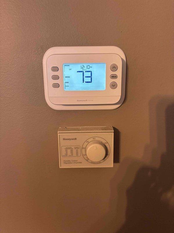 # HVAC Install - Complete System

Successfully installed a complete Lennox heat pump system at the residence. Installation included mounting and wiring a new Honeywell digital programmable thermostat with LCD display, configured to display temperature, time, and system mode settings. Additionally installed a Honeywell humidistat control unit below the primary thermostat for humidity management and adjustment. Commissioned the system and verified proper operation of all controls. Performed temperature measurements on refrigerant lines using digital instrumentation to confirm proper system performance and refrigerant charge levels. All equipment tested and operating within manufacturer specifications upon completion.