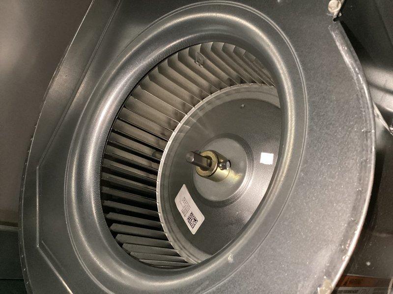 Completed annual cooling system maintenance visit. Inspected blower assembly and motor components, confirming proper operation of squirrel cage blower wheel and motor shaft. Verified outdoor condensing unit accessibility despite heavy vegetation growth around equipment. Installed 20x25x4 air filter as part of routine maintenance. All system components operating within normal parameters at time of service.