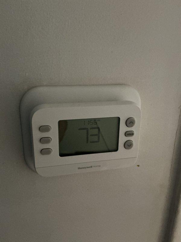 # HVAC Maintenance - Cooling System Service

Completed annual basic cooling maintenance visit on residential HVAC system. Performed comprehensive inspection of cooling equipment including outdoor condensing unit and indoor components. Verified thermostat operation and confirmed accurate temperature reading of 73°F on Honeywell Home digital thermostat. 

Inspected outdoor condensing unit and noted accumulated dust and debris buildup on louvers and protective grilling, which is typical for seasonal operation. Examined air flow patterns through ventilation components. Documented system conditions through photographic records showing thermostat functionality and outdoor unit status.

System operating within normal parameters. Customer enrolled in maintenance agreement with 20x20x4 filter included, renewal date 8/12/26. All routine inspection items completed per annual cooling maintenance protocol.