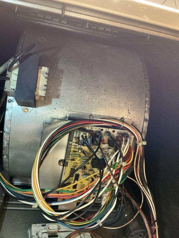 Performed comprehensive AC tune-up on residential air conditioning system. Accessed air handler unit and inspected internal components including blower motor assembly, electrical connections, and control board. Verified all wire connections to circuit board were secure with proper routing of multi-conductor wiring harness. Checked blower motor operation and electrical connector integrity. Used Fieldpiece SC440 clamp meter to measure electrical parameters including capacitance readings of 70.0 MFD and voltage of 211V, confirming proper system operation. Cleaned accumulated dust from interior cabinet surfaces and components. All measurements within manufacturer specifications, system operating normally upon completion of maintenance service.