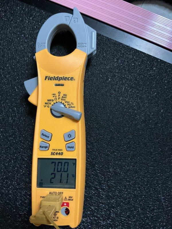 Performed comprehensive AC tune-up on residential air conditioning system. Accessed air handler unit and inspected internal components including blower motor assembly, electrical connections, and control board. Verified all wire connections to circuit board were secure with proper routing of multi-conductor wiring harness. Checked blower motor operation and electrical connector integrity. Used Fieldpiece SC440 clamp meter to measure electrical parameters including capacitance readings of 70.0 MFD and voltage of 211V, confirming proper system operation. Cleaned accumulated dust from interior cabinet surfaces and components. All measurements within manufacturer specifications, system operating normally upon completion of maintenance service.
