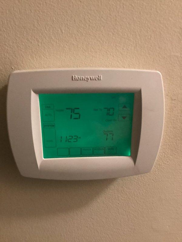 # HVAC Service Report

Responded to emergency no-cooling call on approximately 15-year-old residential air conditioning system. Upon arrival, confirmed complete system failure with no fan operation and no cooling output. Performed diagnostic assessment of thermostat, furnace, and HVAC equipment located in basement mechanical room. Inspected Honeywell digital thermostat showing temperature discrepancies between set point and ambient readings. Evaluated furnace unit, ductwork plenum, and associated electrical and refrigerant connections for potential failure points including compressor, capacitor, contactor, and blower motor functionality.