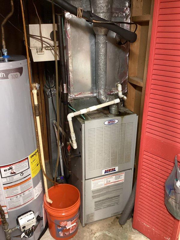 # HVAC Service Report

Responded to emergency no-cooling call on approximately 15-year-old residential air conditioning system. Upon arrival, confirmed complete system failure with no fan operation and no cooling output. Performed diagnostic assessment of thermostat, furnace, and HVAC equipment located in basement mechanical room. Inspected Honeywell digital thermostat showing temperature discrepancies between set point and ambient readings. Evaluated furnace unit, ductwork plenum, and associated electrical and refrigerant connections for potential failure points including compressor, capacitor, contactor, and blower motor functionality.
