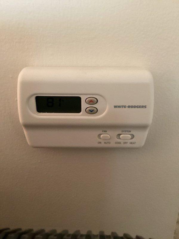 Responded to emergency no-cool call on approximately twenty-year-old residential air conditioning system that had been inoperative for two to three days. Upon arrival, assessed White-Rodgers thermostat operation and verified system controls, then documented equipment condition with photos of thermostat and return air grille for service records.