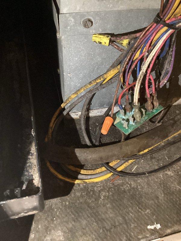 Responded to service call for geothermal system with recurring condensate drain line blockage. Customer reported repeated drain plugging requiring multiple shop vacuum extractions over the weekend with significant water accumulation. Inspected thermostat control panel and internal equipment cabinet, documenting system configuration and wiring conditions. Noted aging electrical components with deteriorated wire insulation on multiple conductors. Cleared condensate drain line obstruction using shop vacuum to restore proper drainage function and prevent water backup into the system.