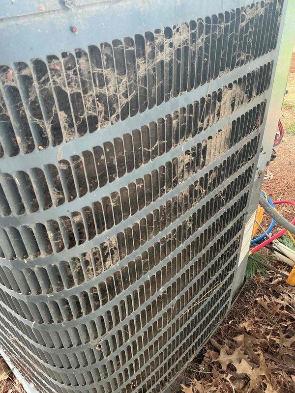 Completed monthly recurring cooling maintenance visit under Basic Plus service plan. Inspected outdoor condenser unit which showed significant accumulation of dirt, dust, and debris on coil fins and grilles, particularly concentrated in upper and middle sections. Assessed indoor air handler unit located in attic space and verified operational status of system components. Replaced 20x20x4 air filter as part of routine maintenance protocol. Documented equipment condition through photographic records showing outdoor unit contamination and indoor air handler installation with associated ductwork and plumbing connections.